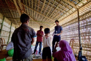 Rohingya interpreter works with doctor explaining medication dosage instructions medical facility Cox's Bazar Bangladesh Kutupalong camp